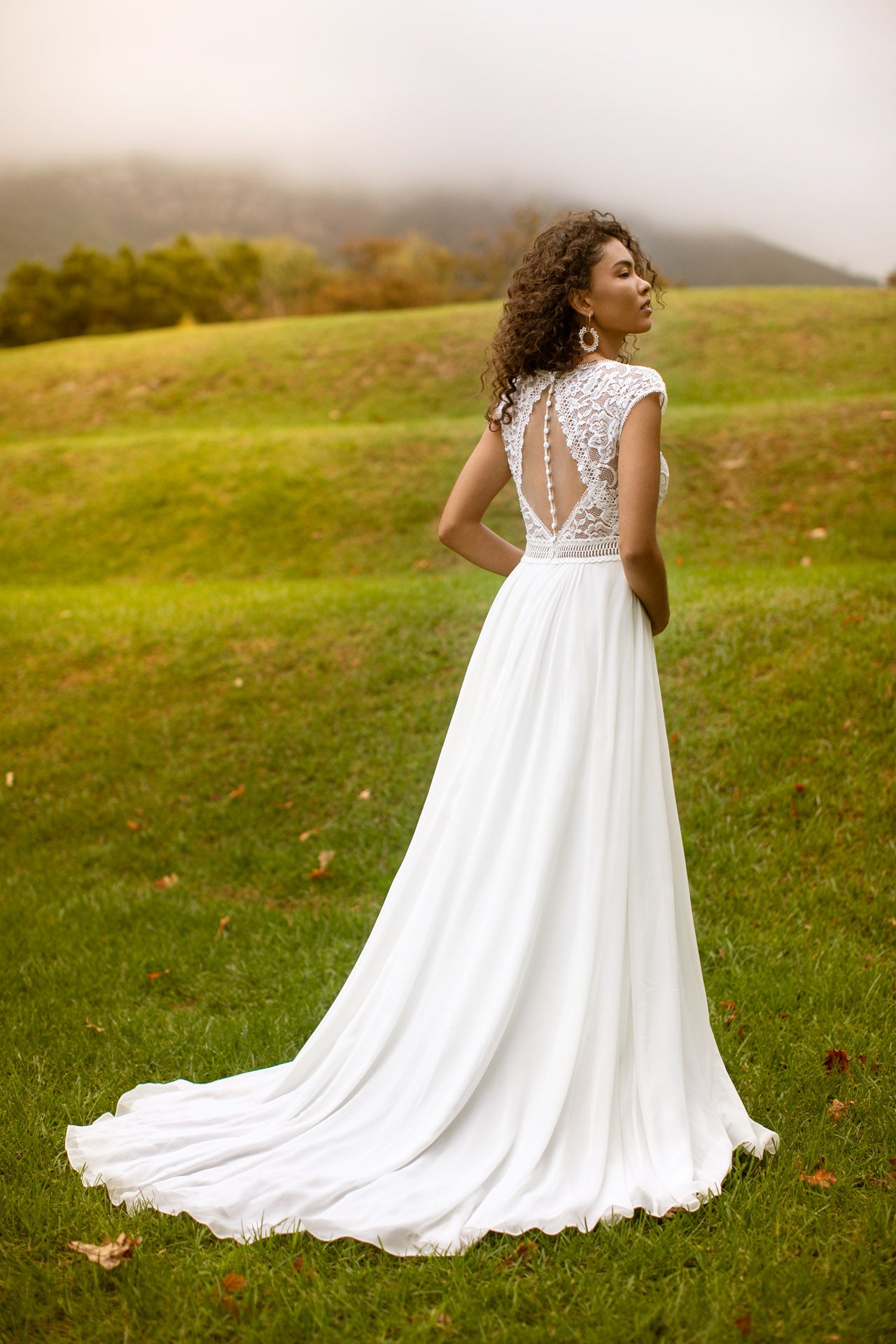 Flattering lace and chiffon wedding dress with V neckline and statement illusion back detail. Kelsey Rose